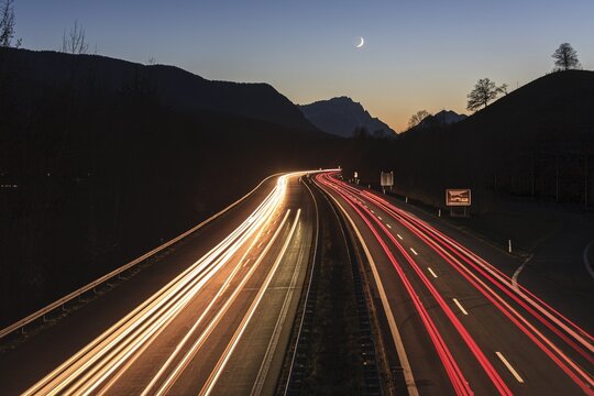 Night shot of a motorway, long exposure, moon, twilight, traffic, car lights, A 95, behind it Zugspitze, Bavaria, Germany
