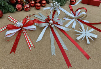 Christmas decoration workshop: scattered ribbons, glitter, glue, and half-finished ornaments