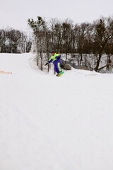 Bearded man carves through fresh snow on a slope, embracing winter sports