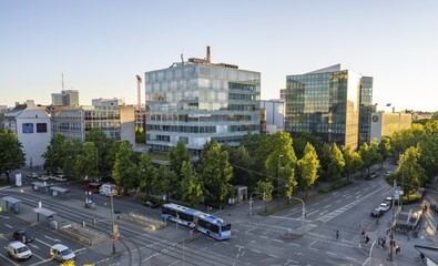 View from above of the crossroads at Stiglmaierplatz with public bus, modern office buildings in the evening light, Löwenbräu brewery building, Stiglmaierplatz, Munich, Upper Bavaria, Bavaria, Germany
