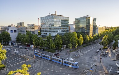 View from above of the crossroads at Stiglmaierplatz with tram, modern office buildings in the evening light, Löwenbräu brewery building, Stiglmaierplatz, Munich, Upper Bavaria, Bavaria, Germany