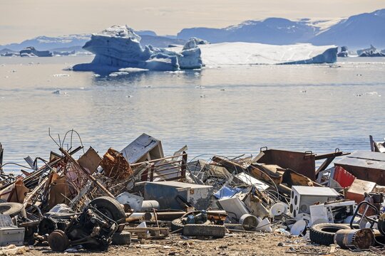 Rubbish dump, waste, electronic waste in front of icebergs in fjord, environmental pollution, Arctic, Uummannaq, West Greenland, Greenland