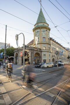 Cyclists crossing the traffic light at red at Stiglmaierplatz, motion blur, L&ouml;wenbr&auml;ukeller of the L&ouml;wenbr&auml;u brewery in the background, Stiglmaierplatz, Munich, Upper Bavaria, Bavaria, Germany