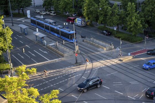 View from above of a road junction with tram and tram stop, cyclists and cars crossing the junction, Stiglmaierplatz, Munich, Upper Bavaria, Bavaria, Germany