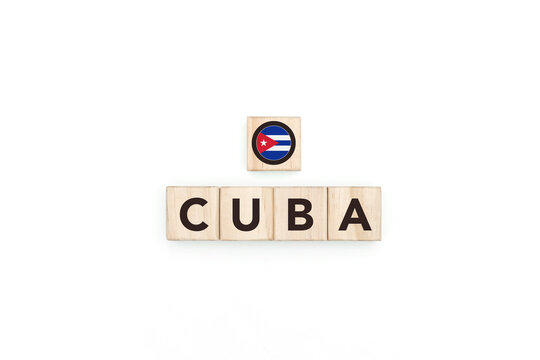 Wooden blocks bearing the name and flag of Cuba. Cuban and Caribbean Culture, national identity, travel, and geography in an advertising space design.
