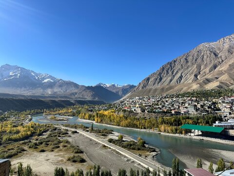 Scenic View of Kargil, Ladakh with Winding River and Golden Trees in Fall.