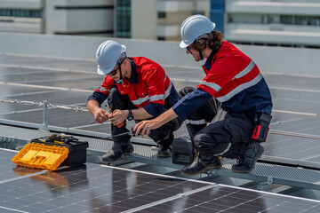 Solar engineer teamwork on rooftop maintenance ensures energy flow with careful repair under bright...