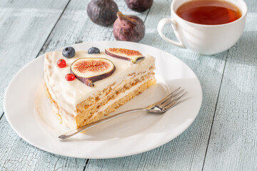 Cake wedge topped berries figs served tea cup rustic cozy setting