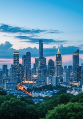 Obraz premium Illuminated cityscape view with modern tall buildings and green trees at night