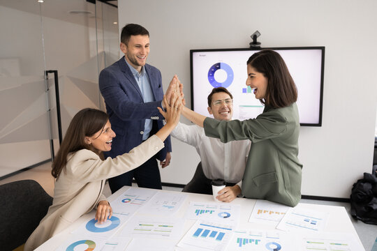 Group of happy young business project managers celebrating success