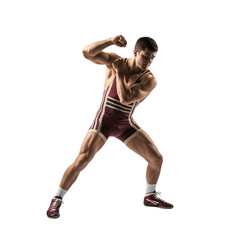 Muscular male wrestler in uniform poses assertively, showcasing athletic physique and strength on black background