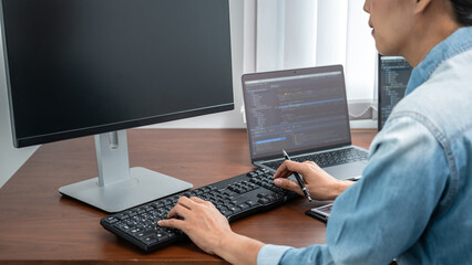 Asian programmer woman holding pen and writing code with data website or data applications