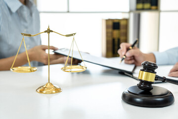 Male lawyer consulting and discussion to businesswoman client at law firm in office, Judge gavel...