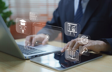 E-learning and online education concept. Businessman using computer to study video tutorials and digital courses. Represents modern learning, self-development, and online study for career growth.