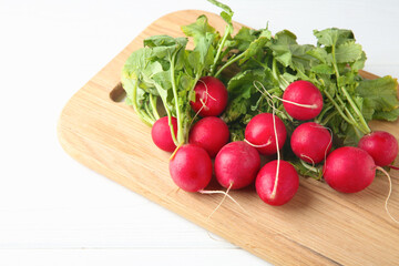Fresh ripe radishes on white table, closeup. Space for text