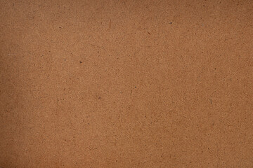 A close up of a warm brown cork board texture for background and design use