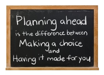 Planning ahead saying handwritten in white chalk on a black chalkboard isolated in a wooden frame