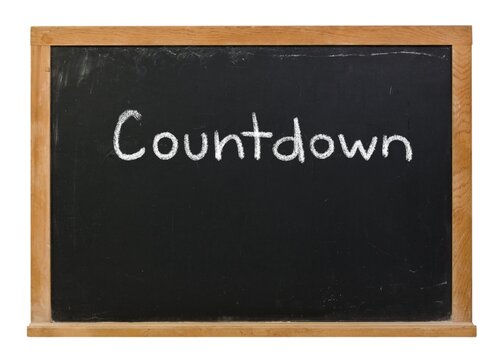 Countdown handwritten in white chalk on a black chalkboard isolated in a wooden frame