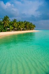 Tranquil closeup calm sea water waves with palm trees. Beautiful Panorama, Tropical island beach landscape exotic shore coast. Summer vacation, holiday amazing nature. Relax paradise, Maldives.