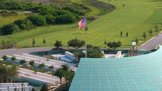 American army Sarasota National Cemetery with rows of white tombstones and USA flag on green grass. Memorial Day concept.