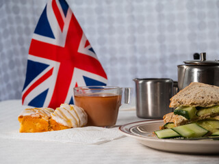 Traditional English tea with jam scone and cucumber sandwiches