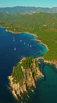  Aerial view of Fort Bregancon sunset aerial view from the mediterranean sea. A yacht is anchored near the fortress