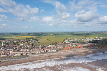 Aerial drone photo of the town of Withernsea in Holderness, East Riding of Yorkshire, England showing the British seaside town with a view of the housing estates and streets by the ocean beach front