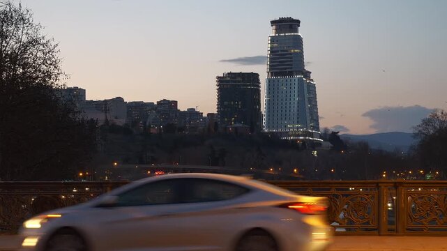 sunset twilight tbailisi city center traffic street riverside bridge slow motion panorama 4k georgia