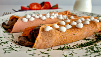 Tomato crepes with cream cheese, close-up