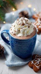 Cozy winter hot chocolate with whipped cream and cocoa sprinkles, served in a rustic blue ceramic mug with festive gingerbread cookies and soft holiday lights in background