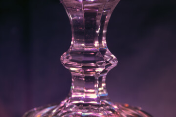 Glass stand illuminated by purple light, background image close-up, futuristic light