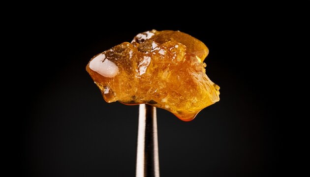 live rosin on a dab tool with a black background