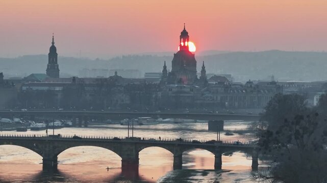 Drone footage of Dresden at sunset &ndash; leftward flight showing Frauenkirche, bridges, flooded Elbe River, and old town.
