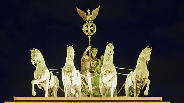 Berlin, Germany -15.08.2025: Quadriga statue on Brandenburg Gate with illumination in the evening, Berlin. Germany