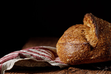 Rustic sourdough bread on black background