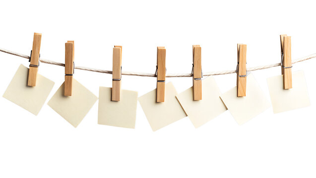 Empty white pages and sheets clipped to clothesline with rustic wooden pegs, on transparent background