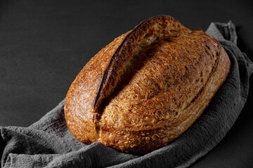 Rustic sourdough bread on black background