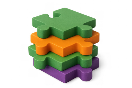Stacked colorful puzzle pieces forming a tower, representing business concepts like solutions, integration, strategy, and collaboration