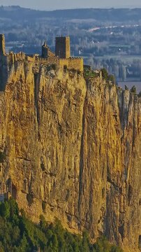  Mornas Fortress stands majestically on top of a rocky cliff. The Fortress of Mornas is a medieval fortress above the village of the same name in the French department of Vaucluse