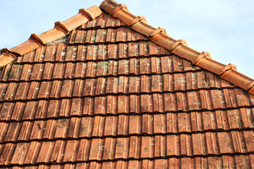 The roof of the house is covered with old red tiles