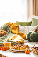 Autumn Table Setting with Pumpkin-Shaped buns with Cinnamon, Apples, Pumpkins, and Cozy Decor