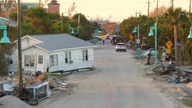 Trash from severely damaged houses after hurricane Milton storm surge. Piles of debris on street side on Manasota key street in Florida. Consequences of natural disaster.
