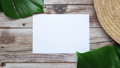 Blank paper with tropical leaves on wood perfect for summer message or creative work