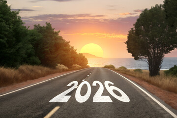 The road to 2026: A scenic coastal journey towards a hopeful future and a new beginning at sunrise.
 Generative Ai.