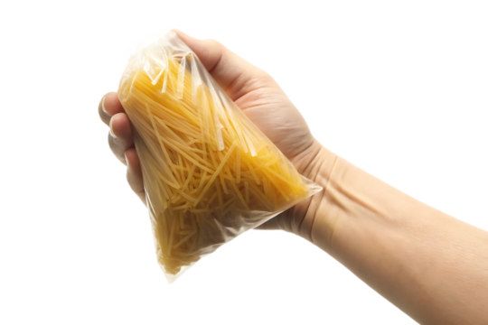 Hand holding clear plastic bag with spaghetti isolated on a transparent background