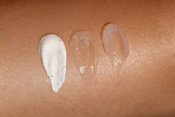Different skincare product textures on womans skin.