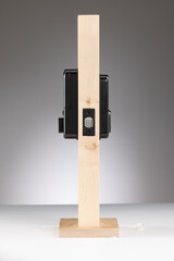 Modern wooden stand with black electronic device mounted