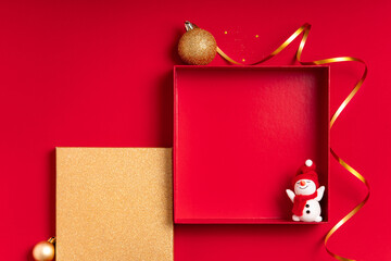 Red frame background with ribbon, snowman and golden panel