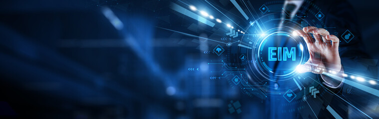 Businessman hand hold EIM dashboard. Data governance and content management integration. Analytics, compliance, workflow, digital storage, business intelligence, and enterprise efficiency.