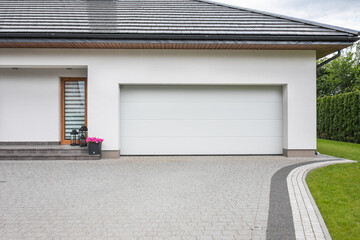 Designer entrance gate to garage. Modern design. Luxurious exterior. Facade of a modern garage.